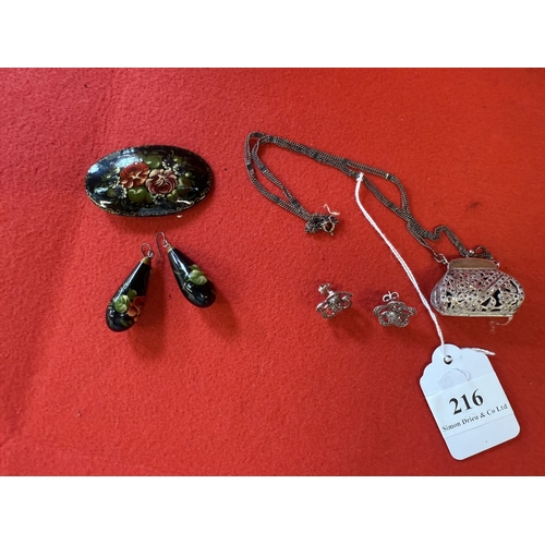 216 - A vintage silver and marcasite pendant modelled as a handbag and suspended from a chain together wit... 