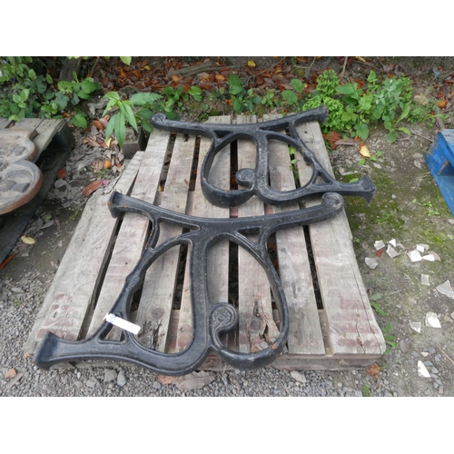 100 - A pair of substantial cast iron bench ends