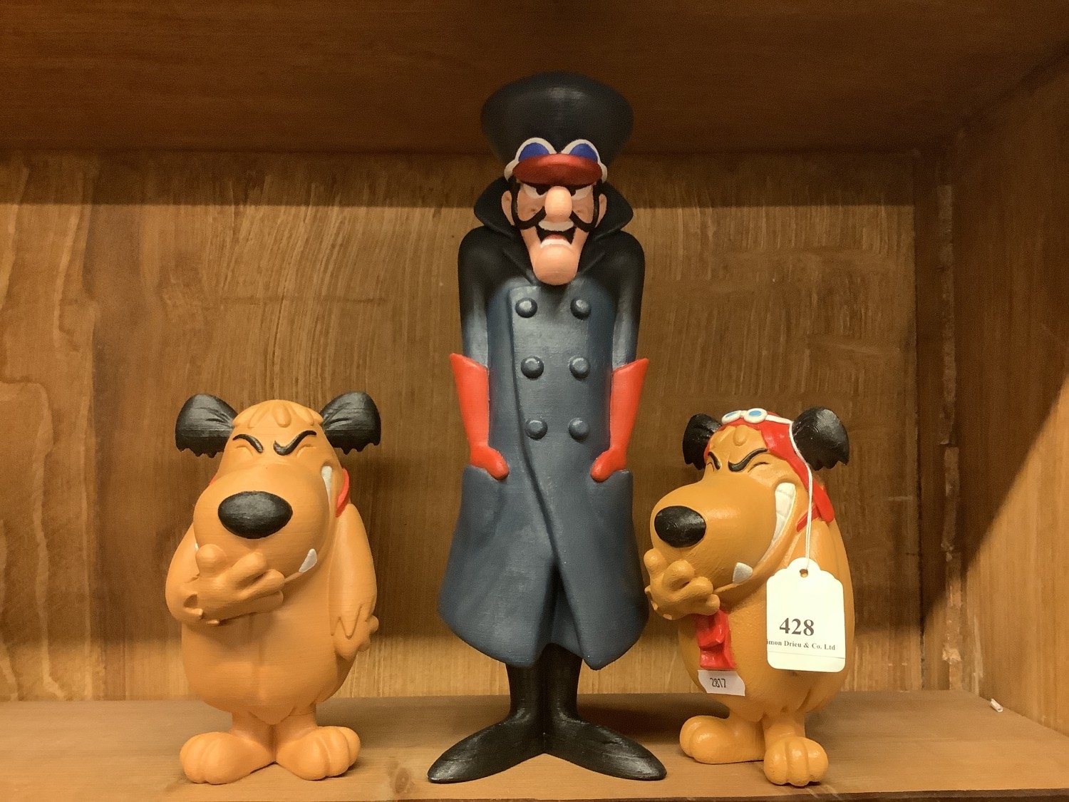 A figure of Dick Dastardly together with two of Muttley