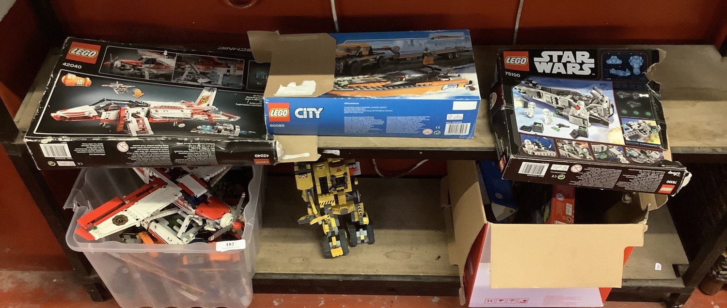 A varied assortment of Lego and Lego modelling kits