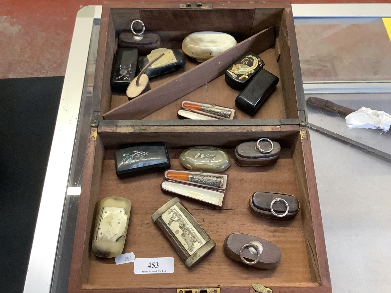 A collection of snuff boxes together with two cheroot holders
