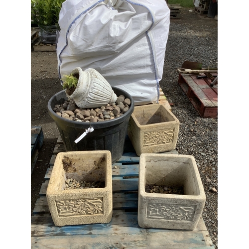 59 - A set of three reconstituted stone planters together with a quantity of pebbles and an urn