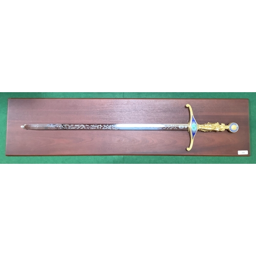 A Wilkinson sword Millennium sword mounted upon mahogany