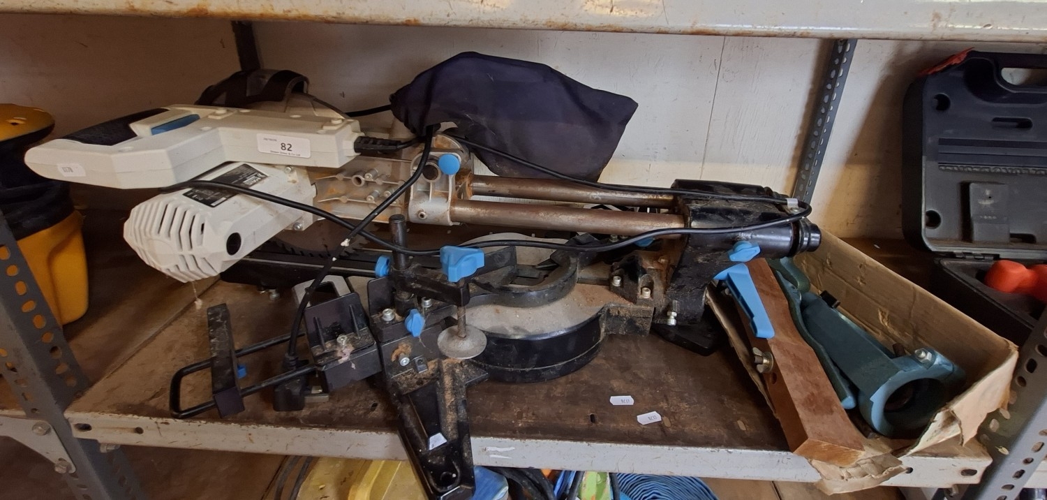 A Mac Allister sliding compound mitre saw together with a wood ...