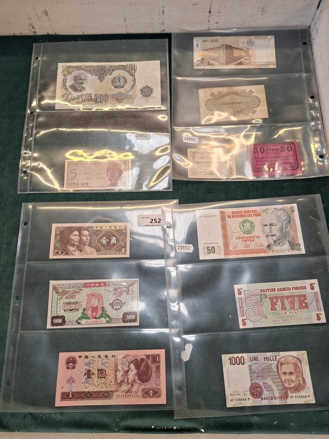 A collection of vintage bank notes and tokens