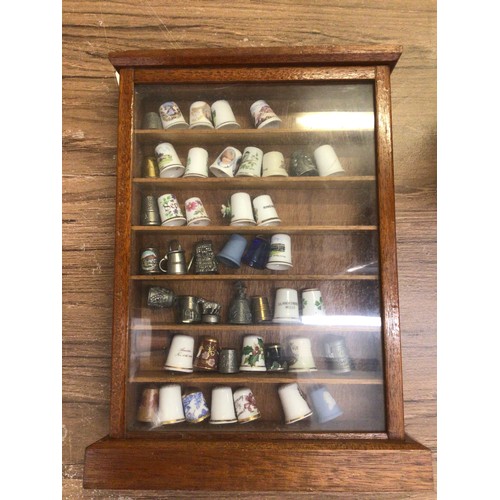 7 - Collection of thimbles in display case