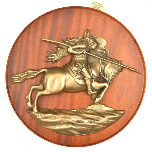 560 - A cast brass badge of HMS Resolution, battleship 1915-48, showing a mounted warrior in horned helmet... 