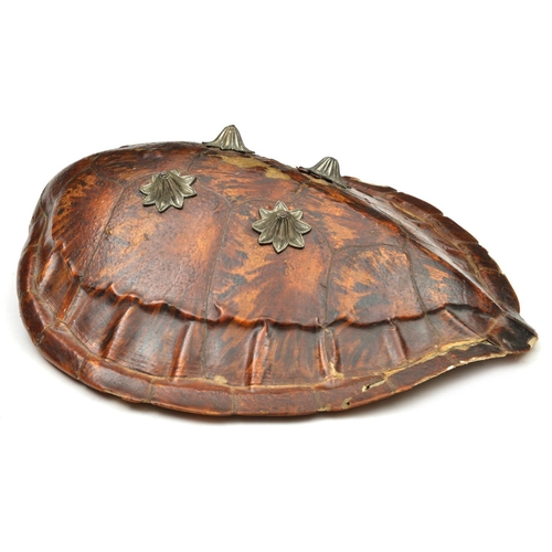 157 - A Rajasthani shield made from a turtle shell. 48 x 44cms, fitted with 4 fluted bosses of flower-head... 