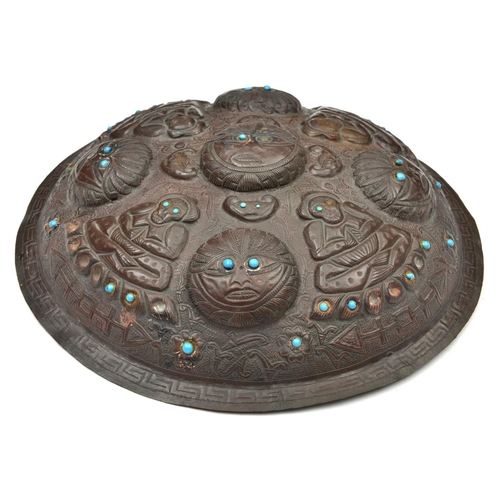 186 - A Tibetan or North Indian border copper shield. 20th century, embossed with 4 seated buddha-like fig... 
