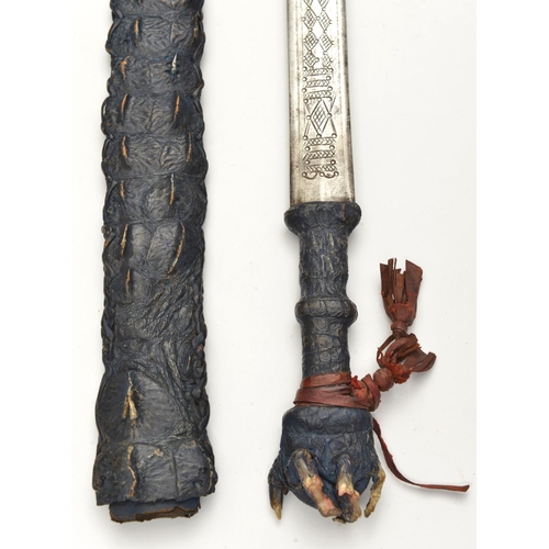 191 - A Sudanese short sword. Early 20th century, straight DE blade 61cms chiselled with geometric ornamen... 