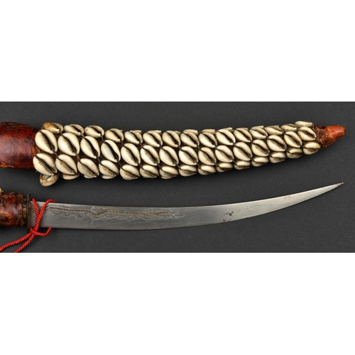 194 - A North African littoral dagger. early 20th century, curved SE blade 26cms engraved and inlaid with ... 