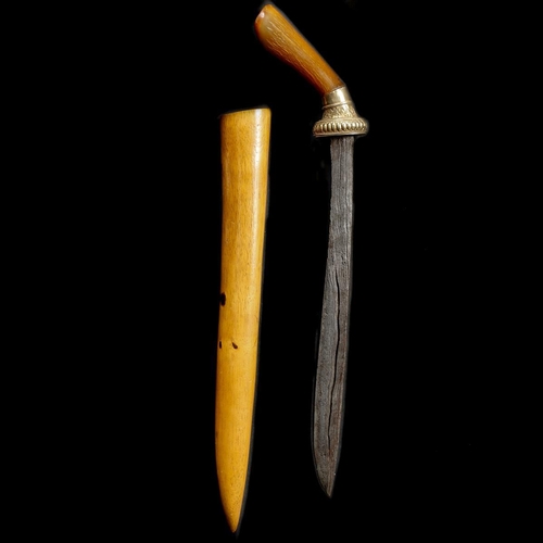 145 - A Javanese dagger badek. Early 20th century, pattern welded single edge blade 30.5cms pierced along ... 