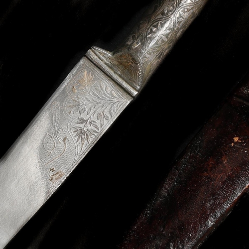 173 - An Indian dagger kard. SE blade 20cms, iron hilt and forte silver damascened with flowers and foliag... 