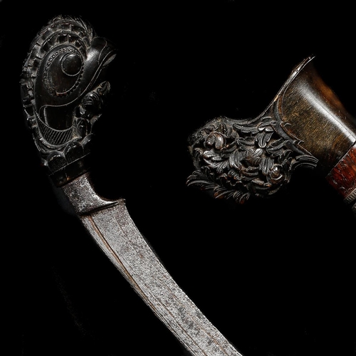 180 - A Malayan dagger tumbok lada. Late 19th century, curved single edge blade 21cms, horn  hilt carved w... 