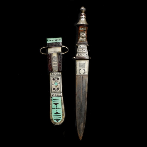 187 - A North African tribal knife. Straight DE blade 16cms, wooden hilt and leather sheath with good qual... 