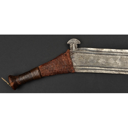 193 - An African Nsakara tribal knife enono. Late 19th century, broad DE blade 53cms of boomerang shape wi... 