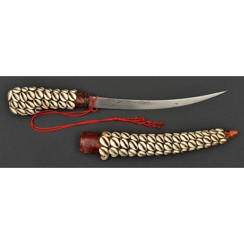 194 - A North African littoral dagger. early 20th century, curved SE blade 26cms engraved and inlaid with ... 