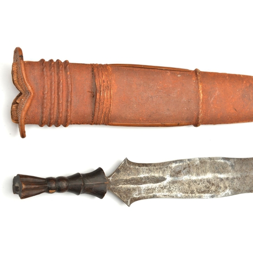 195 - An African Salampasu head hunter’s tribal knife. Early 20th century, broad DE blade 42.5cms, carved ... 