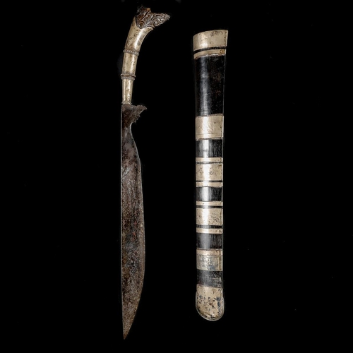 223 - An Indonesian sword, probably Bali 19th century. Swollen SE straight 41cms, tall silver mounted hilt... 