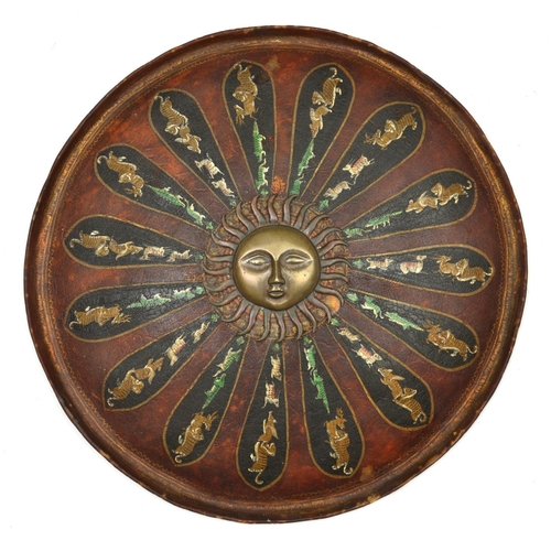 243 - An Indian lacquered shield dhal. c.1900, 46cms, with central brass boss formed as a radiant sun, lac... 