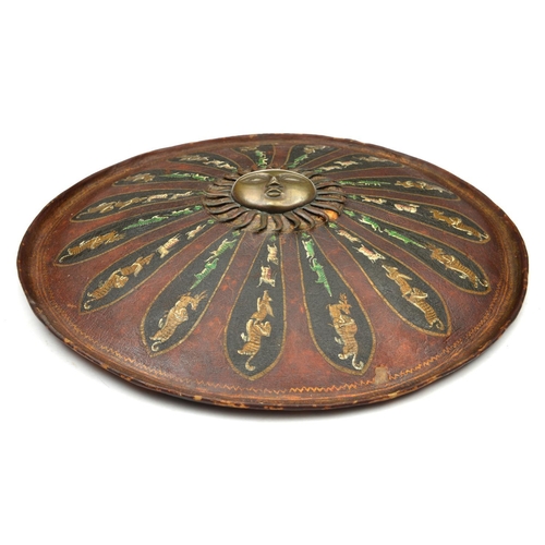 243 - An Indian lacquered shield dhal. c.1900, 46cms, with central brass boss formed as a radiant sun, lac... 