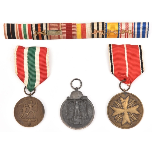 381 - Three Third Reich medals: Order of the German Eagle bronze medal of Merit without swords, Return of ... 