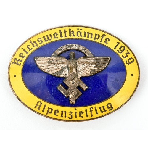 392 - A Third Reich pin back oval enamelled badge, superimposed in the centre is the NSFK symbol on blue g... 