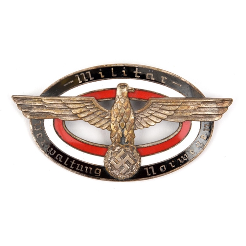 394 - A Third Reich oval enamelled pin back badge for the German Administration in Norway, having an eagle... 