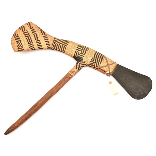 543 - A Polynesian axe, grey stone head and long basket weave axe head shaped tail, 29” overall, on short ... 