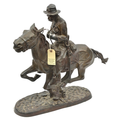 601 - A darkened cast brass figure of a 19th century US cavalry man, on galloping charger, with full equip... 