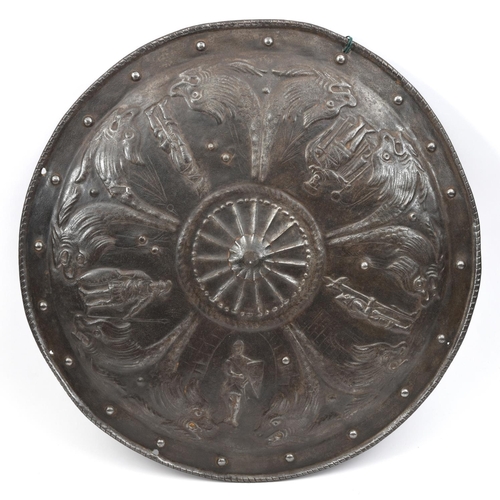 631 - A circular embossed iron parade shield, in the style of the 16th century, with 5 knights and courtly... 