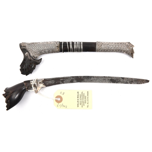 36 - A Celebes knife, Bade Bade, forge welded blade 8” with plain silver mount and ferrule, the carved da... 