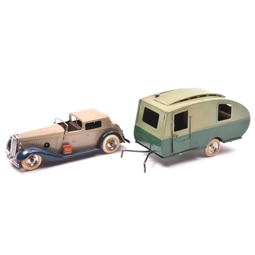 1174 - 2 Tri-ang Minic tinplate toys. A clockwork Town Coupe No.7m  An example in light grey with dark blue... 