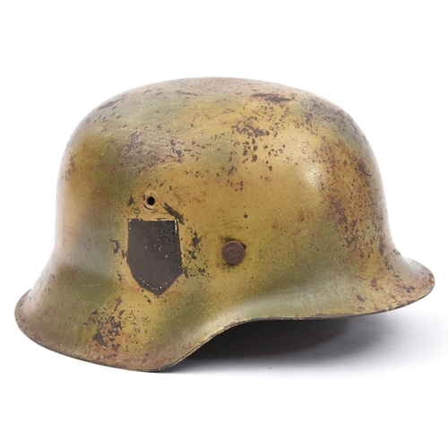 210 - A Third Reich M42 steel helmet, with camouflage finish, the single decal removed, maker’s mark “ET66... 