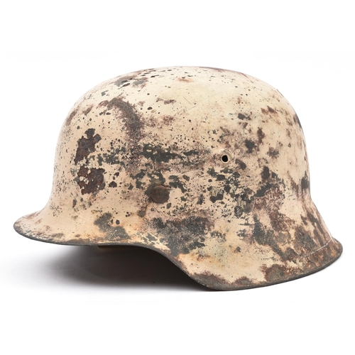 211 - A Third Reich M42 steel helmet,  with textured white camouflage finish for use on the Russian front,... 