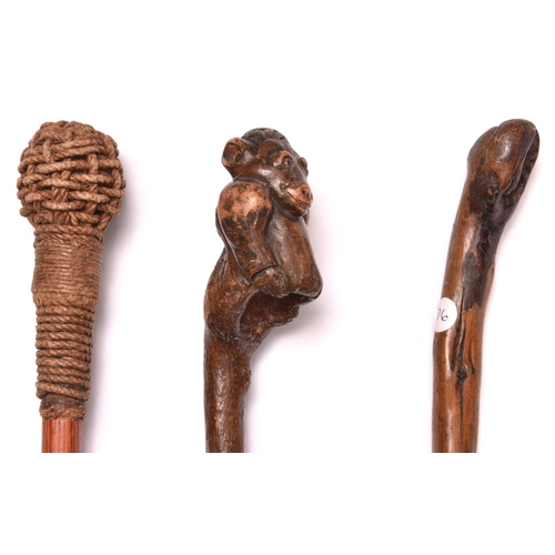 148 - A knotted darkwood walking cane,  the rootwood top carved in the form of a gorilla torso, brass ferr... 