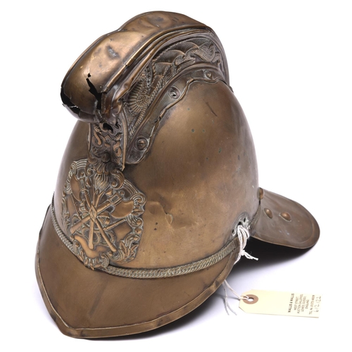 152 - A  fireman’s brass helmet by Merryweather, c 1900, with front and back peaks, ornamental crest and c... 