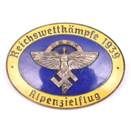 198 - A Third Reich oval enamelled pin back badge,  superimposed in the centre is the NSFK emblem in oxidi... 