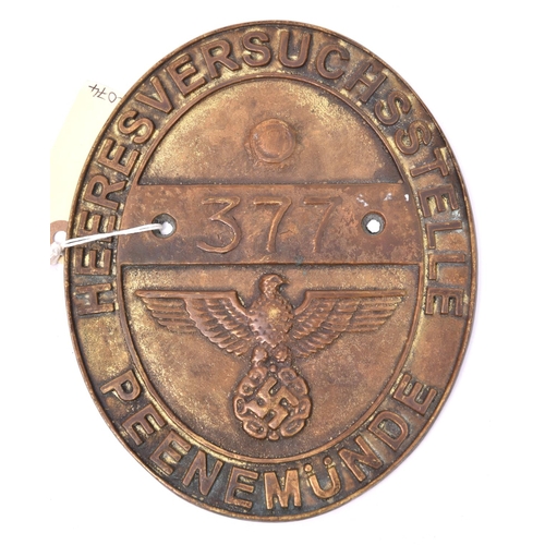 202 - A Third Reich oval cast brass plaque, inscribed around the rim “Heeresversuchsstelle Peenemunde”, an... 