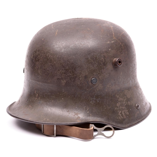 208 - A German WWI M16 steel helmet,  with original grey painted finish, the inside rear rim painted with ... 