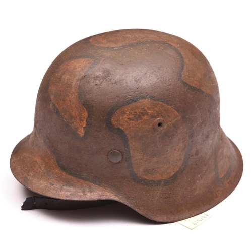 209 - A Third Reich M42 steel helmet,  with later WWI style camouflage finish and leather liner and chinst... 