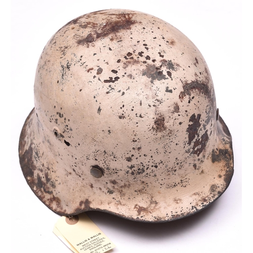 211 - A Third Reich M42 steel helmet,  with textured white camouflage finish for use on the Russian front,... 