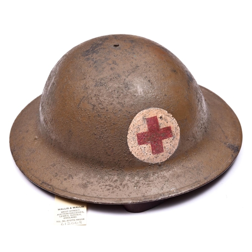 247 - A WWI US Red Cross Brodie’s pattern steel helmet, painted red cross on white in roundel, leather chi... 