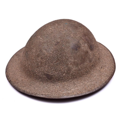 252 - A WWI Brodie’s pattern steel helmet,  rough sanded finish, leather chinstrap with owner’s no and ini... 