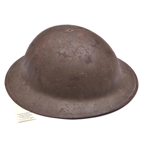 253 - A WWI Brodie’s pattern steel helmet,  oilcloth, netting, leather and fabric lining, fragment of chin... 