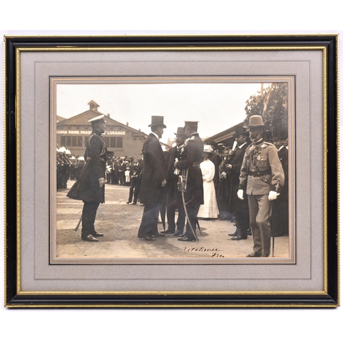 12 - An early 20th century signed photograph of F. Marshal Lord Kitchener, wearing peaked cap and frock c... 