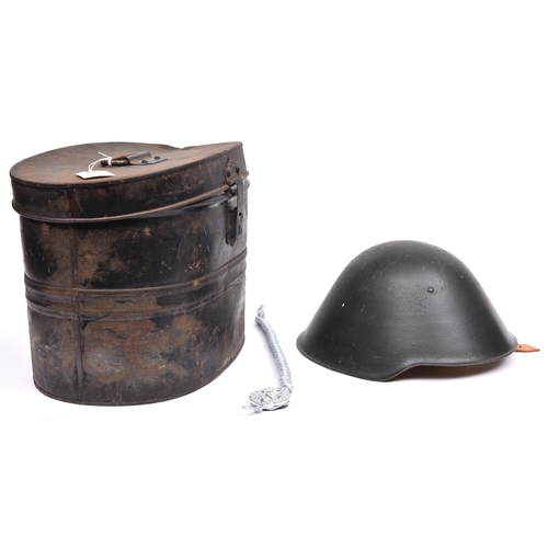 223 - An E German Volksarmee steel helmet, dark green with pale brown leather padded liner and chinstrap; ... 