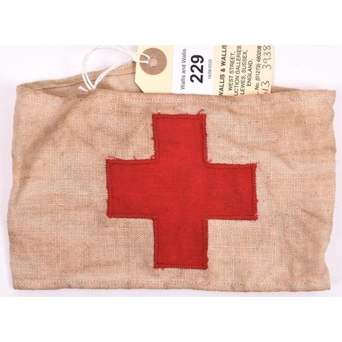 229 - A Red Cross buff linen armband, with superimposed cross, the back bearing indistinct Air Ministry st... 