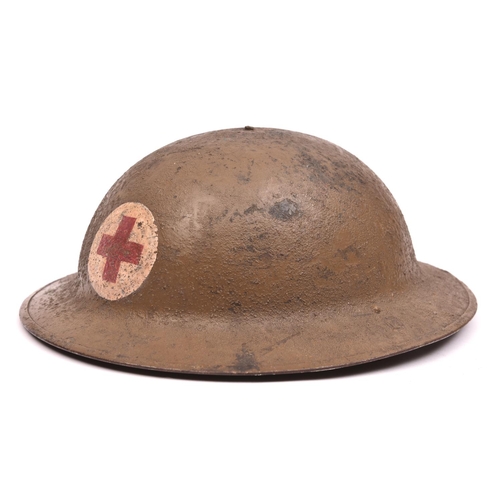 A WWI US Red Cross Brodie s pattern steel helmet painted red