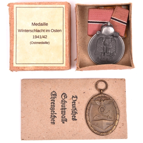 105 - Third Reich Eastern Front medal, in card box with printed label, and West Wall medal with printed pa... 